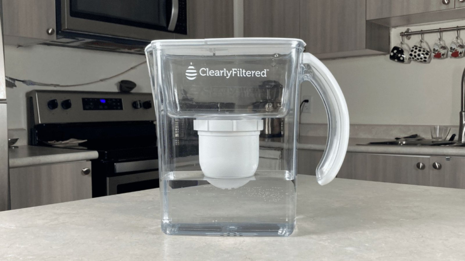 Clearly Filtered water pitcher highlighting sleek transparent design in modern kitchen with stainless steel decor.