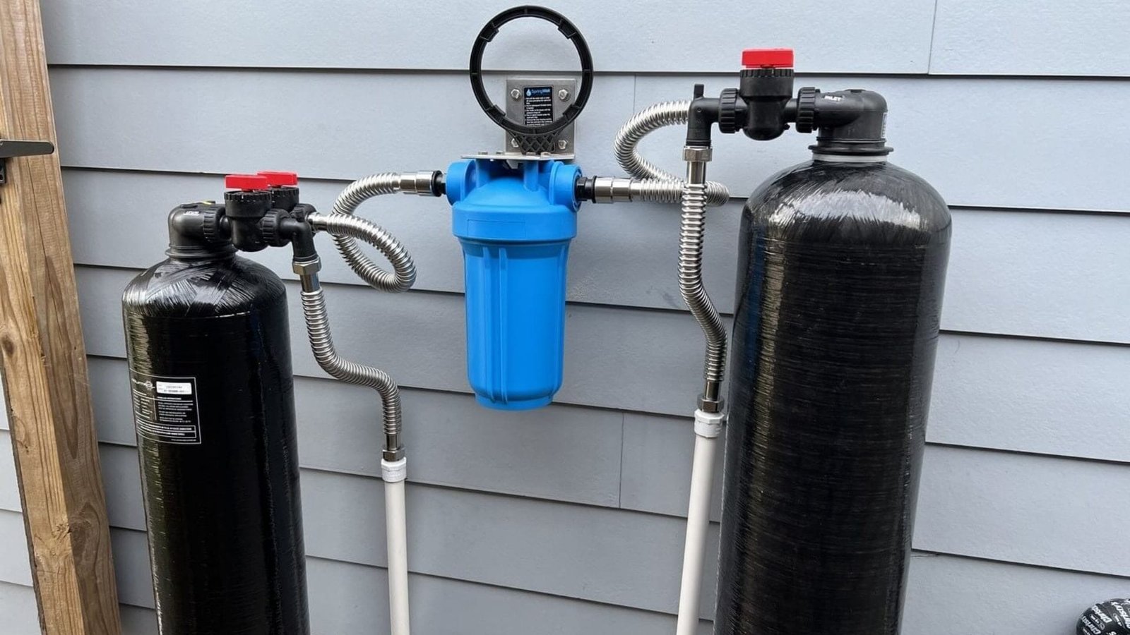 Springwell Cf Series whole house water filter system with black tanks and blue filter housing.