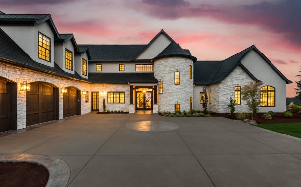 Tankless water heater size luxury home exterior featuring stunning sunset and modern classic architecture.