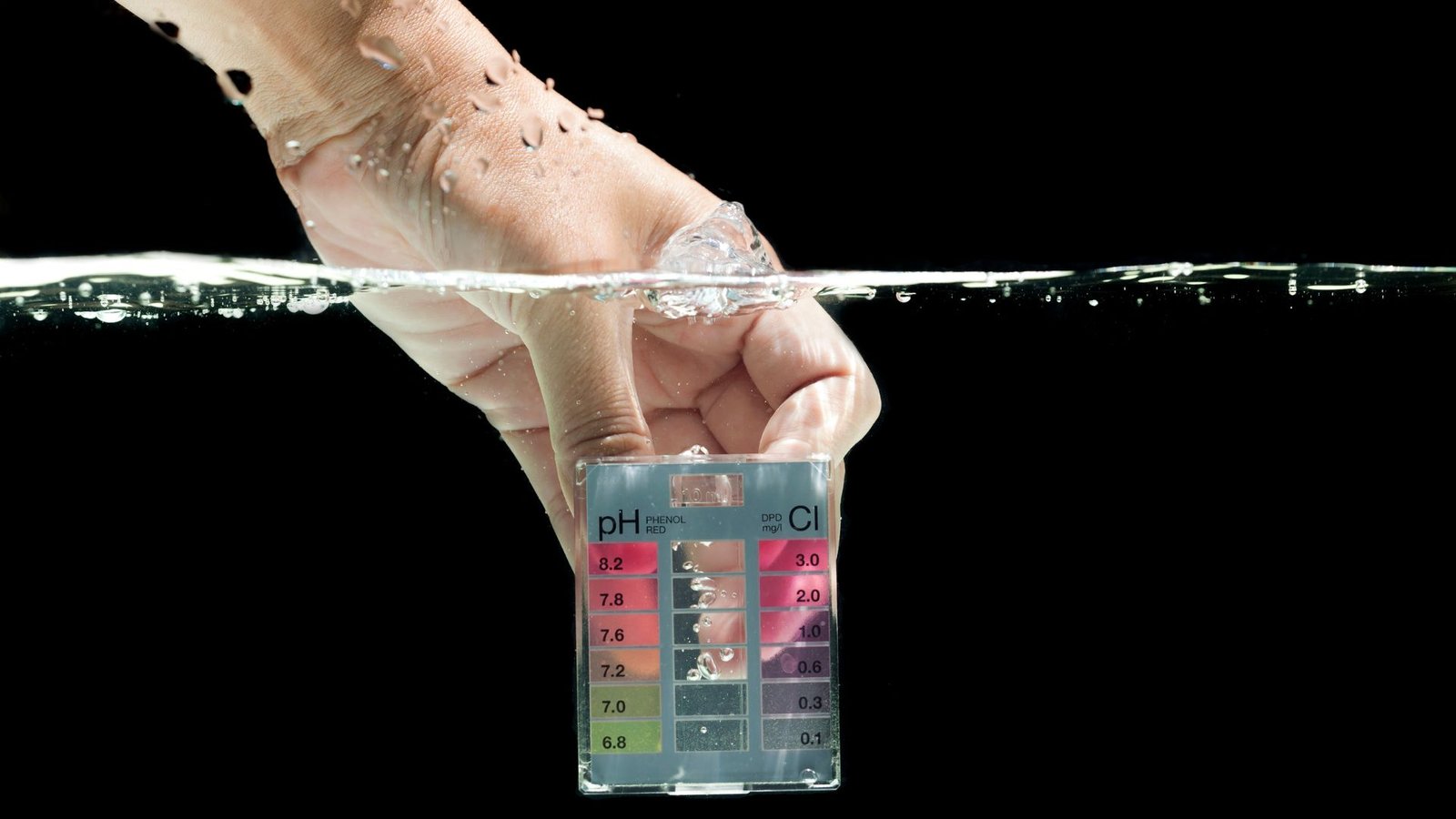 Alkaline water vs distilled water pH testing kit submerged in water showcasing vibrant color-coded pH levels.