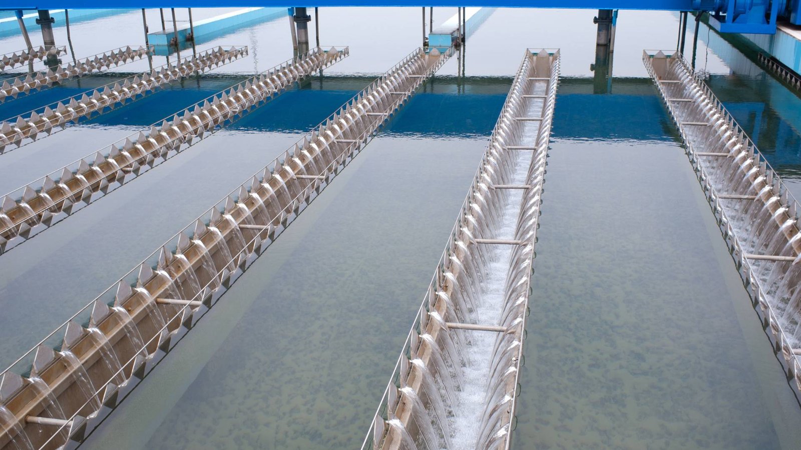 Home water testing facility depicting modern sedimentation tanks with comb-like weirs for debris removal.