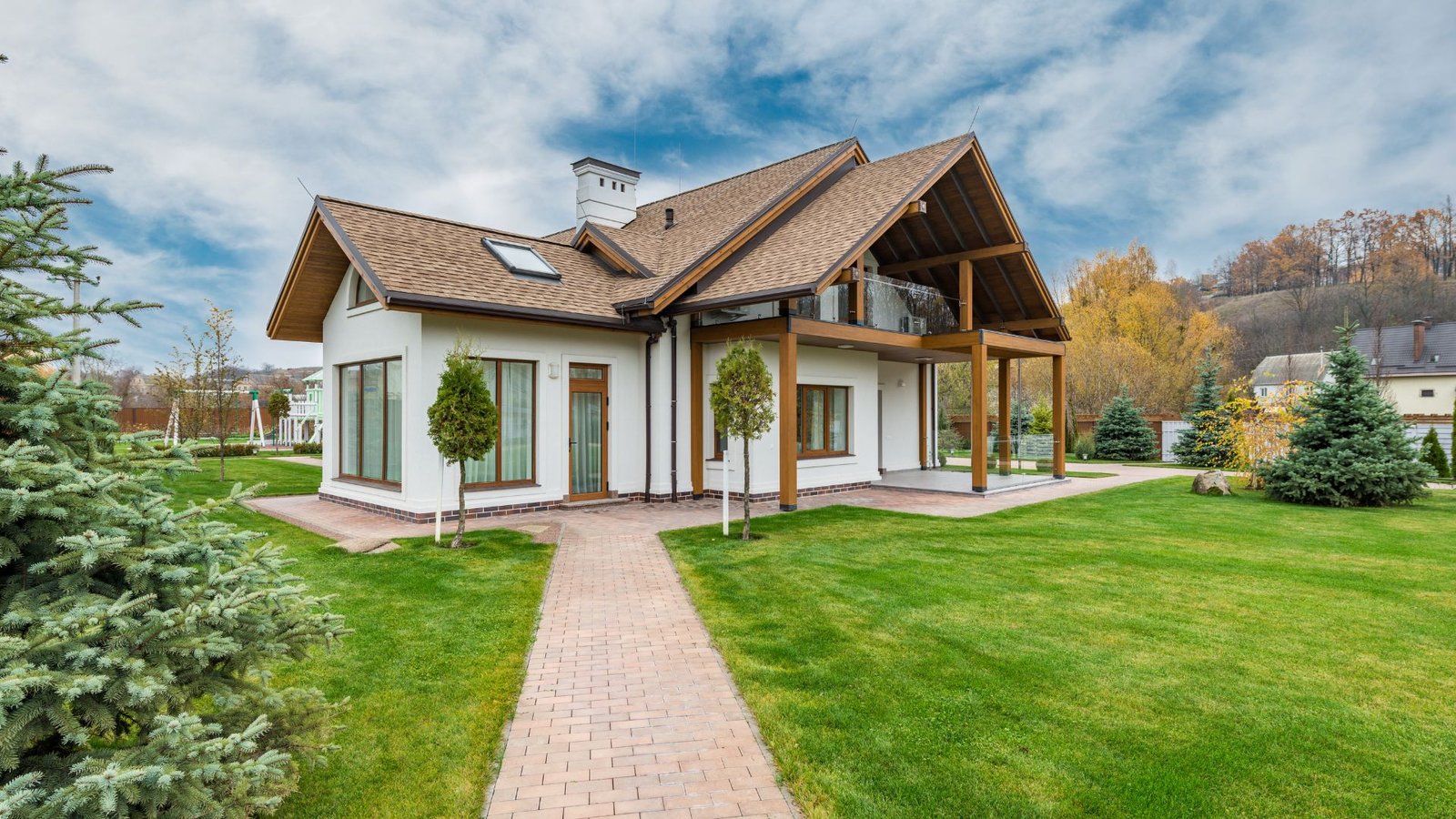 Tankless water heater depicted in a modern, two-story house with a lush garden and veranda.