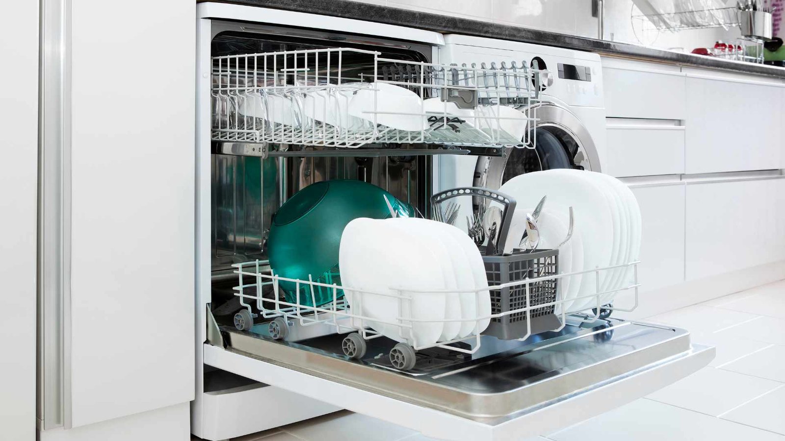 Water Bills Modern Kitchen Dishwasher open with neatly arranged dishes highlighting efficiency and convenience.