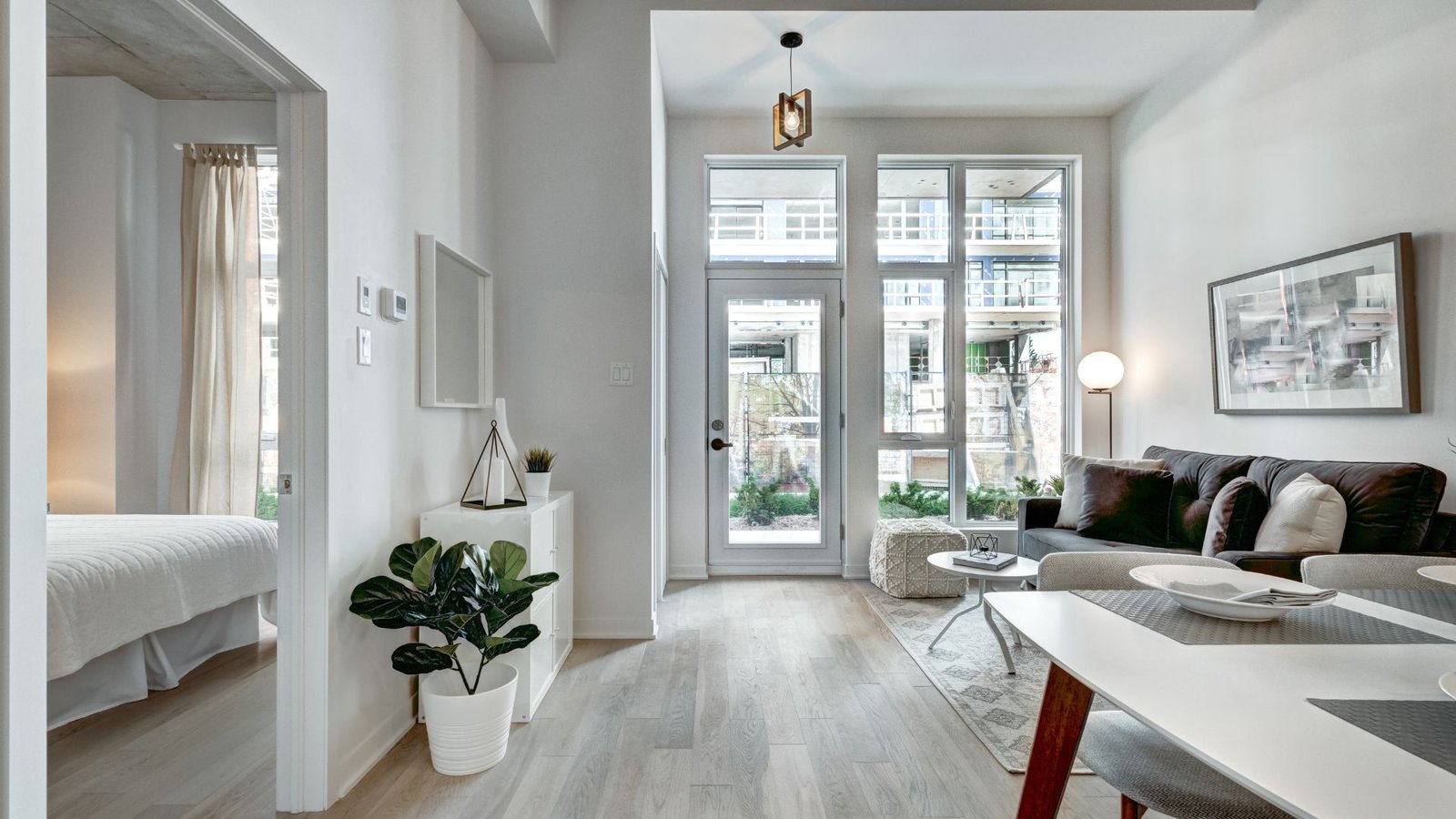 Apartment water softener setup in a modern open plan apartment with minimalist dining and living spaces.