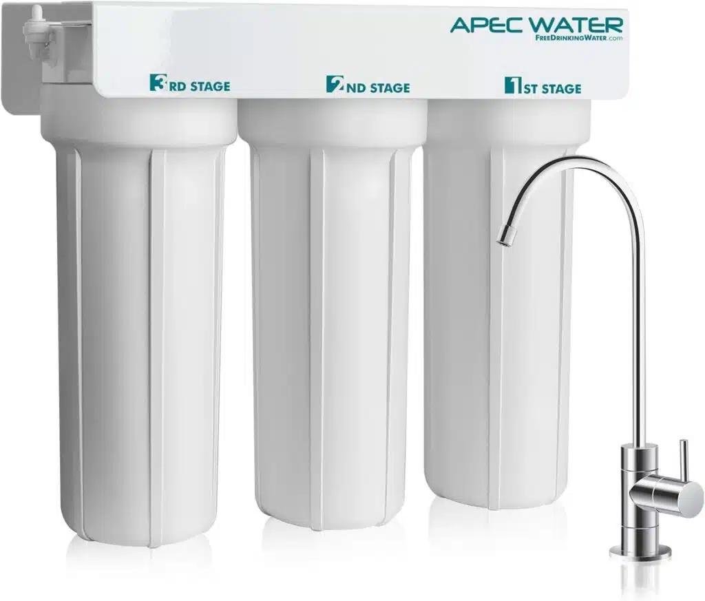 Apec water system Apec WFS 1000 three-stage filtration unit with labeled canisters and elegant kitchen faucet.