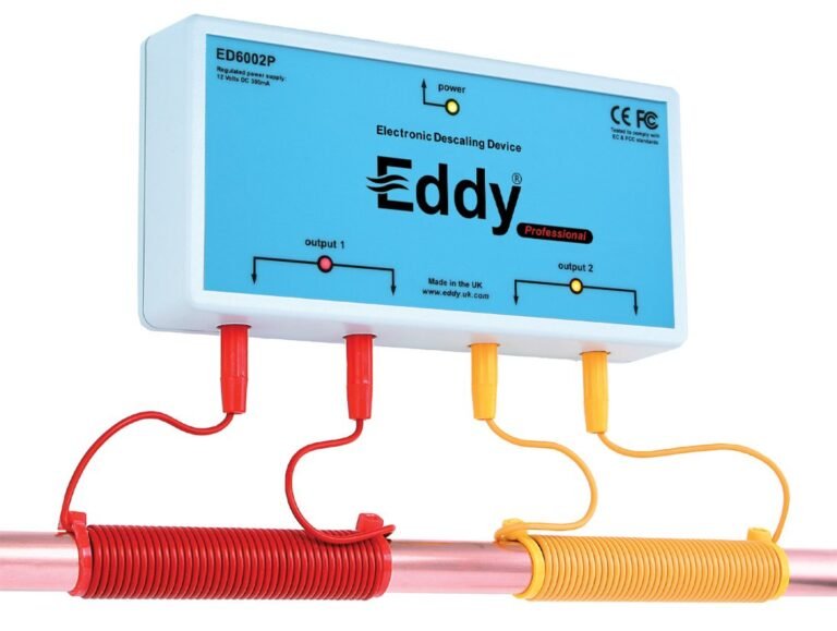 Eddy Electronic Water Descaler device with colored cables reducing mineral deposits in copper pipes.