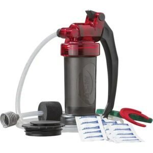 Portable water filter MSR Miniworks filter with red pump handle and accessories for emergency use.