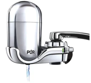 Recycle water filters PUR sleek chrome filtration system attached to a modern kitchen faucet.