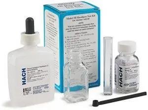 Water test kit Hach set including dropper, glass bottle, test tube, and stirring rod for analysis.